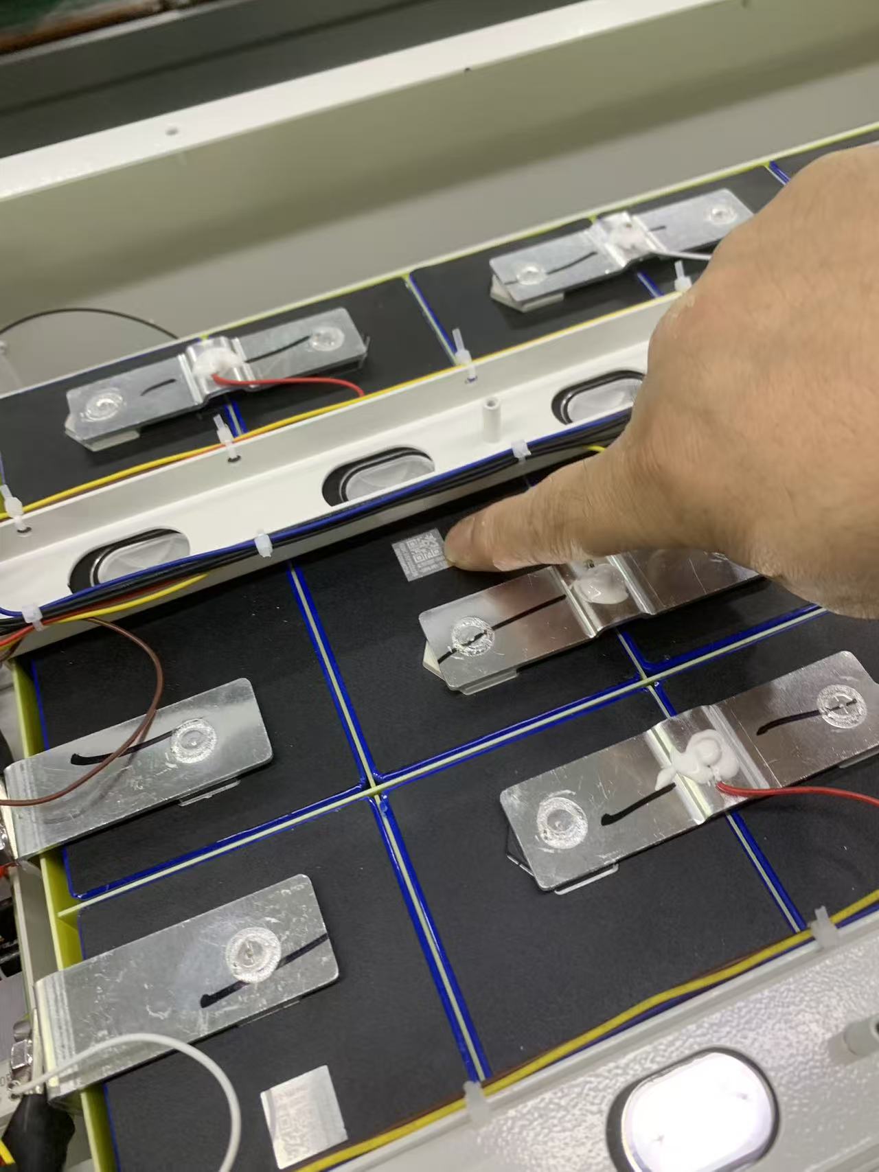 Weld inspection — busbar joints checked at the line